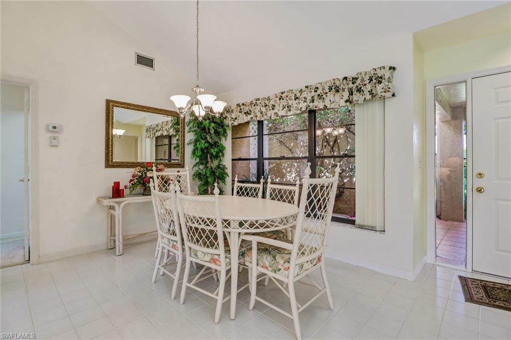 805 Reef Point Circle Naples, FL 34108 - Photo 8 of 33 a dining room with furniture and window