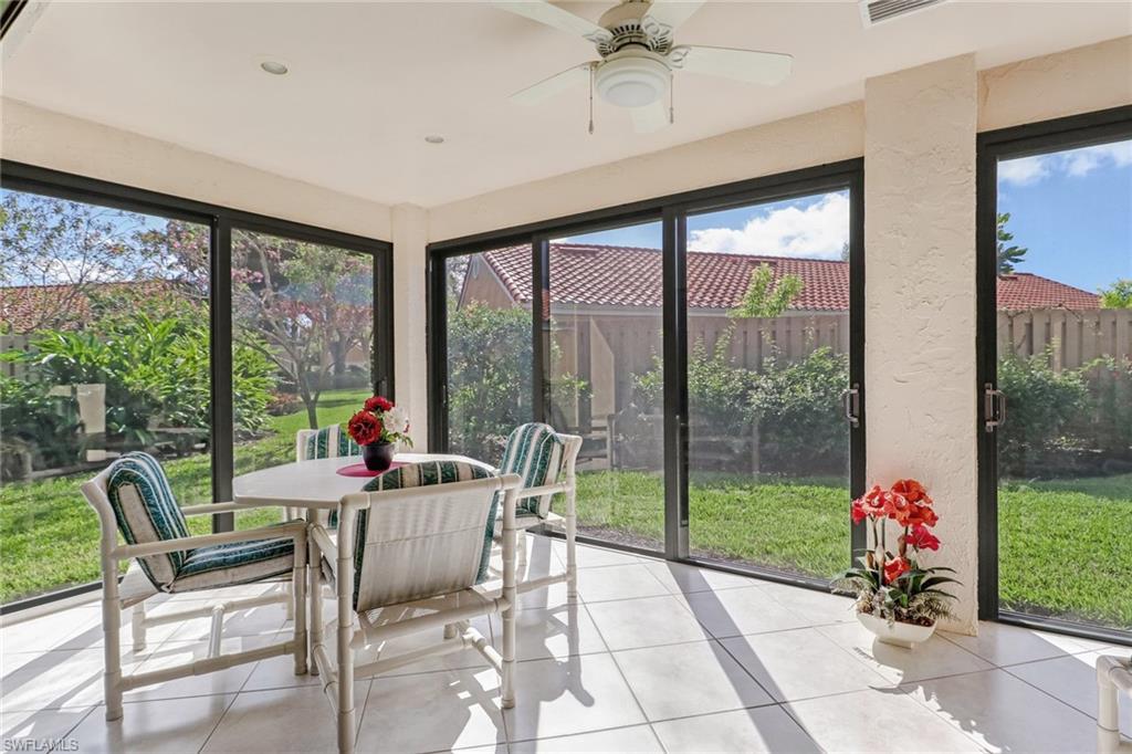 805 Reef Point Circle Naples, FL 34108 - Photo 10 of 33 a living room with a large window and a table