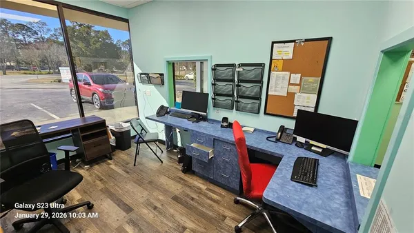 a work room with furniture and a floor to ceiling window