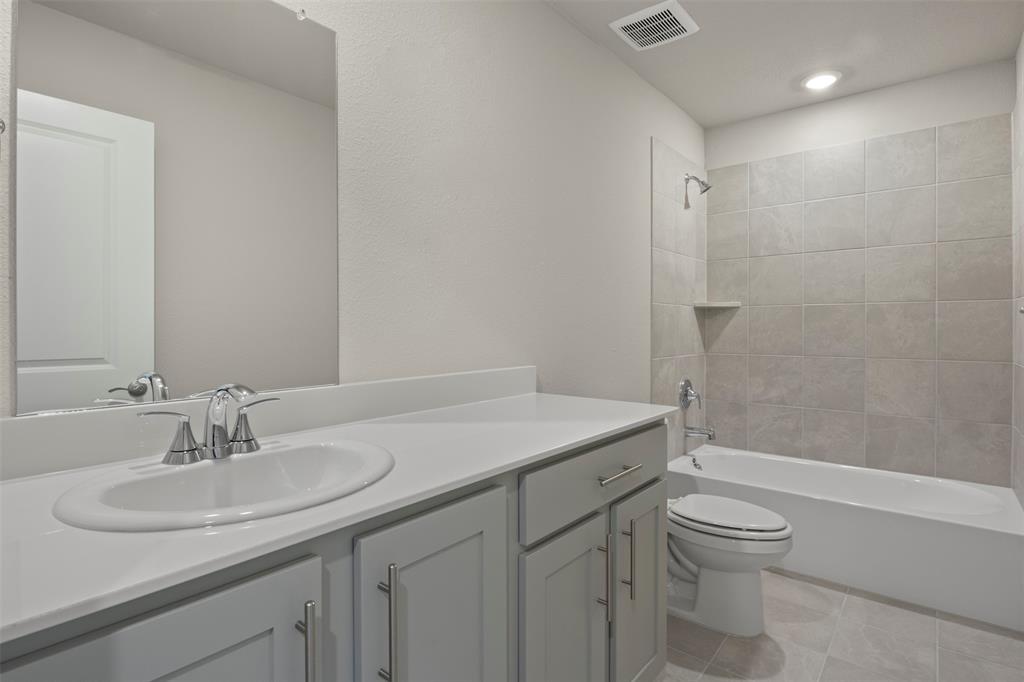 2220 Currents Road Princeton, TX 75407 - Photo 25 of 31 Vanity with an integrated sink, polished chrome faucet, gray cabinetry, and a full-width mirror