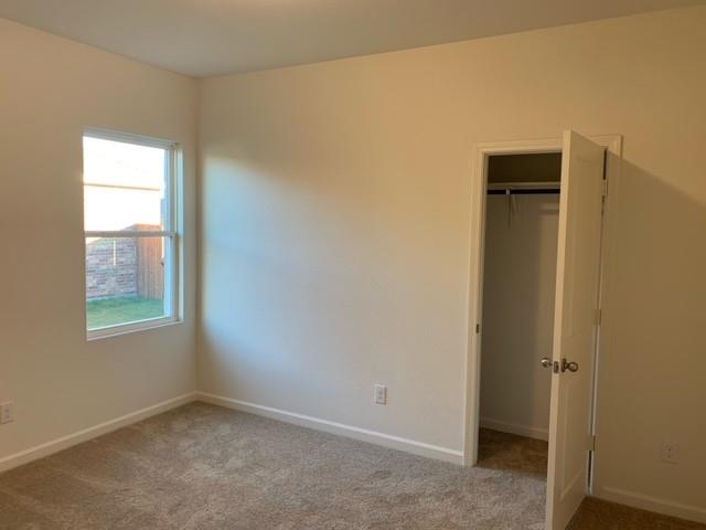 604 Indian Creek Anna, TX 75409 - Photo 6 of 12 a view of an empty room with window and closet area