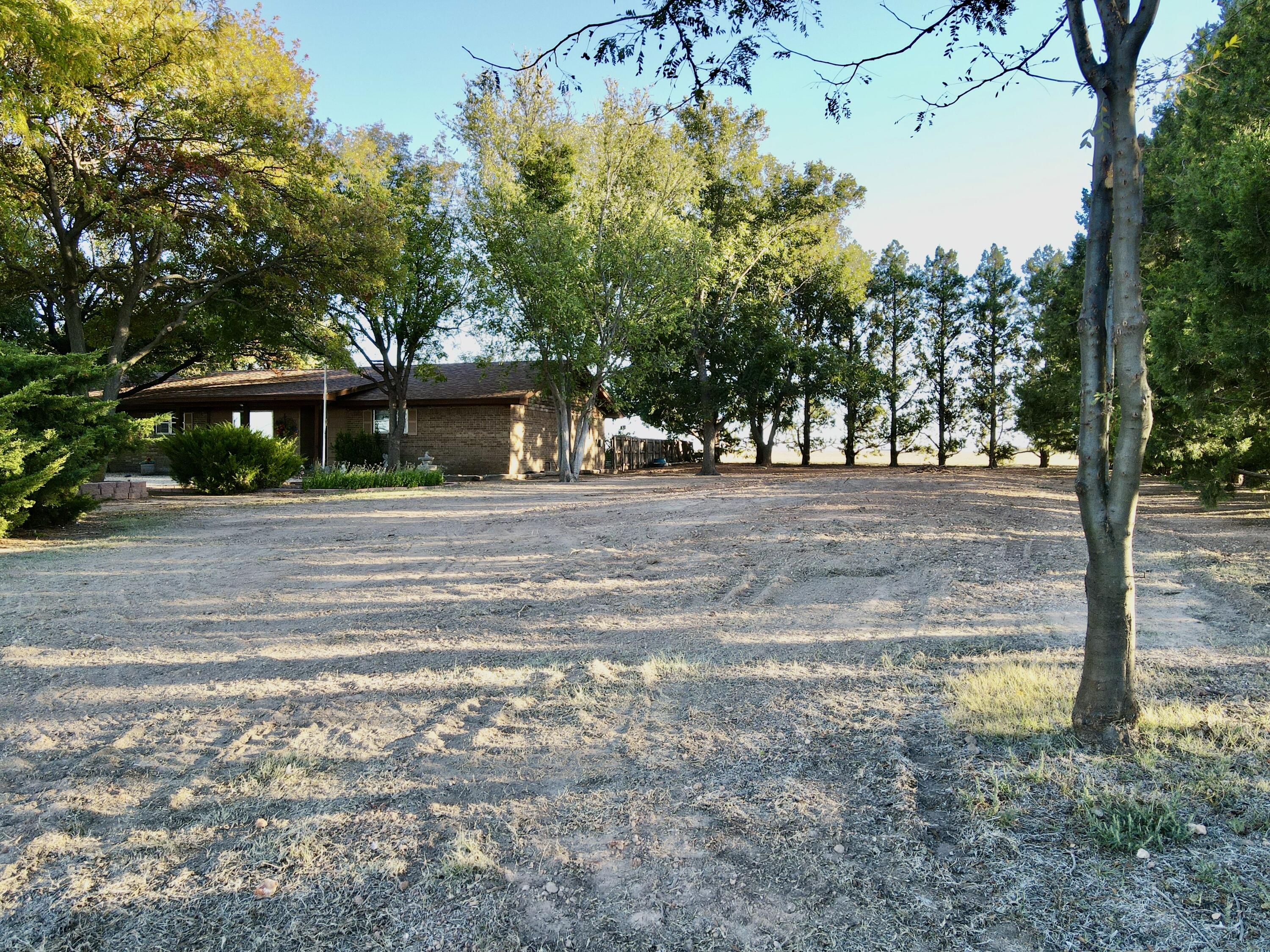 7844 Fm 1318 Tulia, TX 79088 - Photo 15 of 42 a front view of a house with a yard
