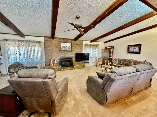 a view of a dining room with furniture and a chandelier