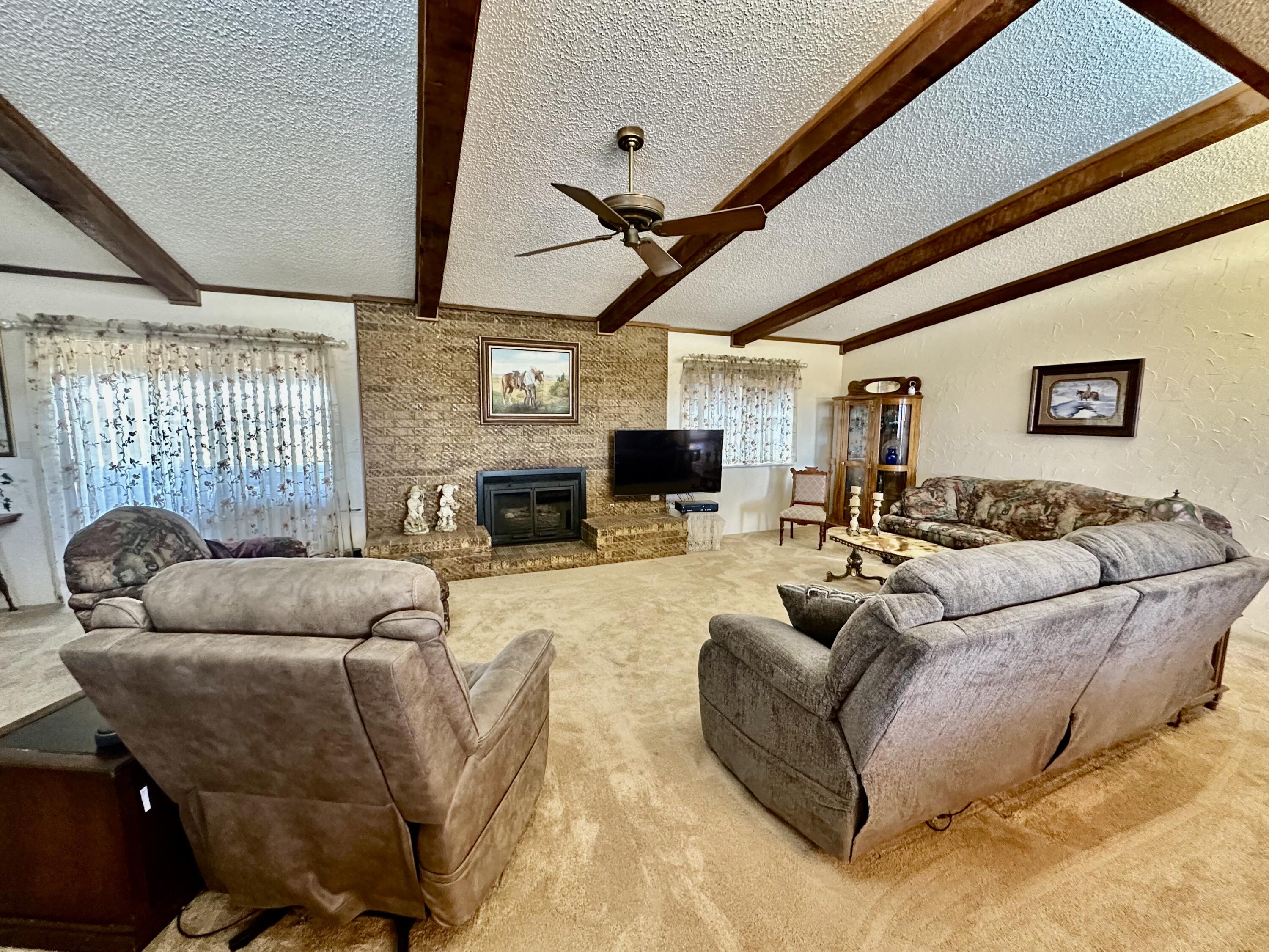 7844 Fm 1318 Tulia, TX 79088 - Photo 18 of 42 a living room with furniture a fireplace and a flat screen tv