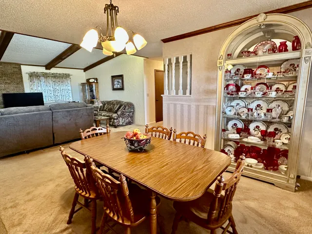 a kitchen with stainless steel appliances granite countertop stove top oven a sink dishwasher and cabinets with wooden floor