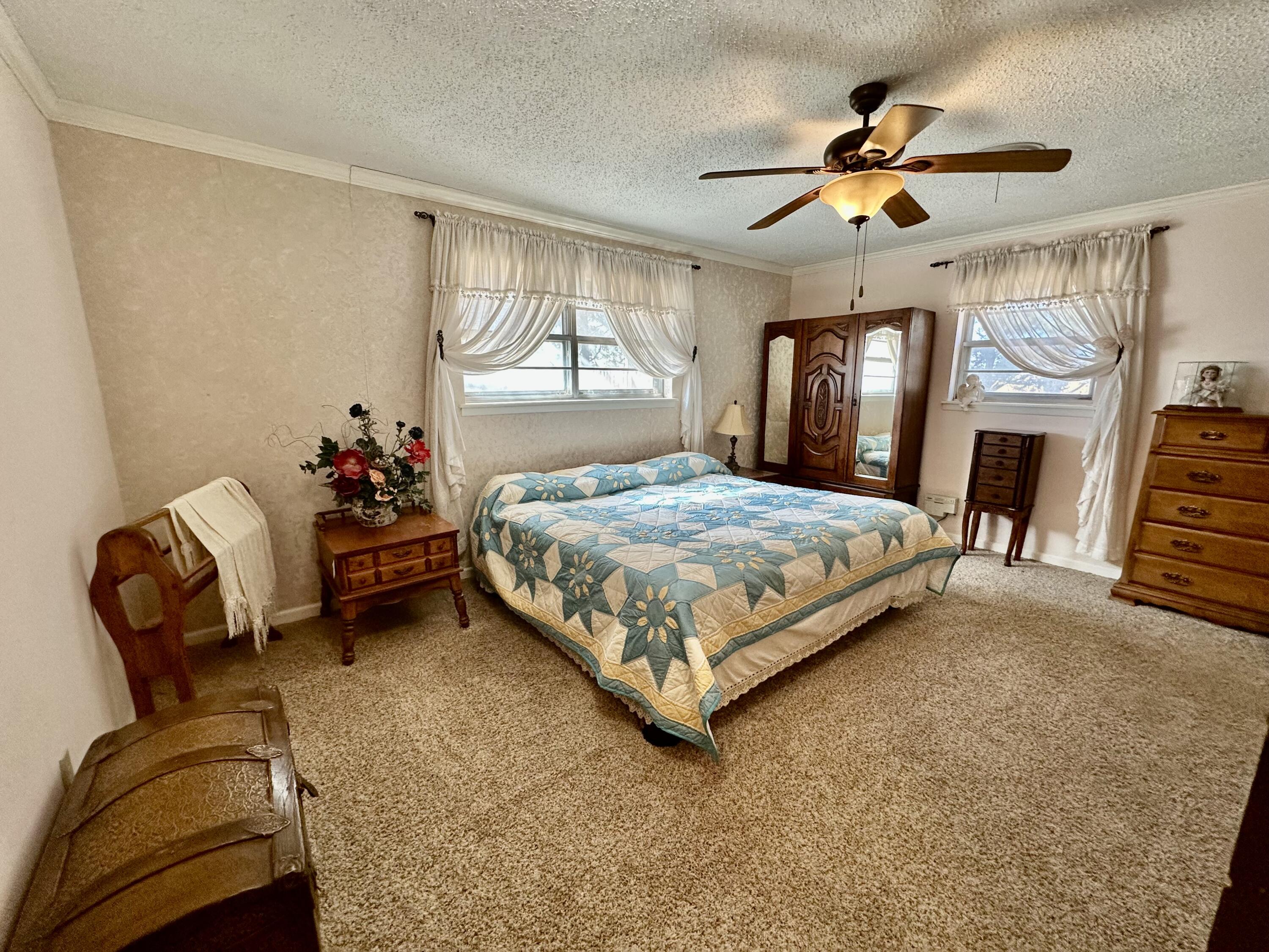 7844 Fm 1318 Tulia, TX 79088 - Photo 24 of 42 a bedroom with a bed dresser and a window