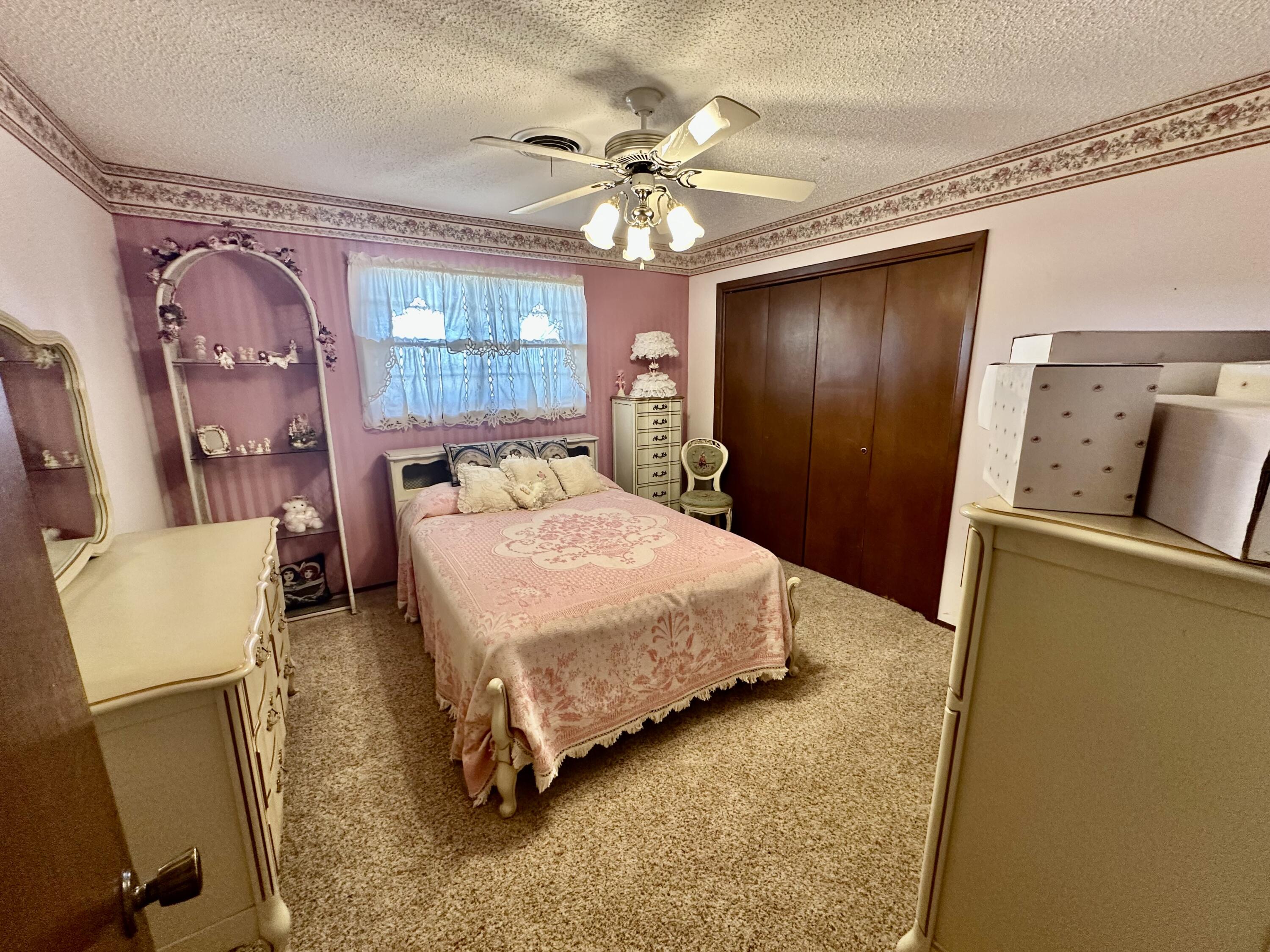 7844 Fm 1318 Tulia, TX 79088 - Photo 28 of 42 a bedroom with a bed dresser and wooden floor