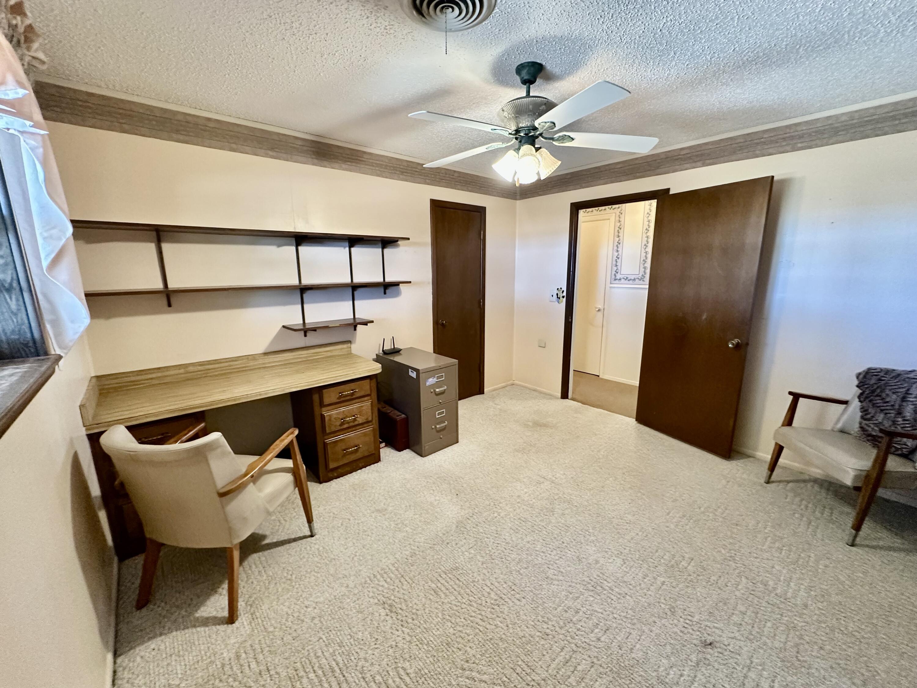 7844 Fm 1318 Tulia, TX 79088 - Photo 29 of 42 a bedroom with a bed and a chandelier