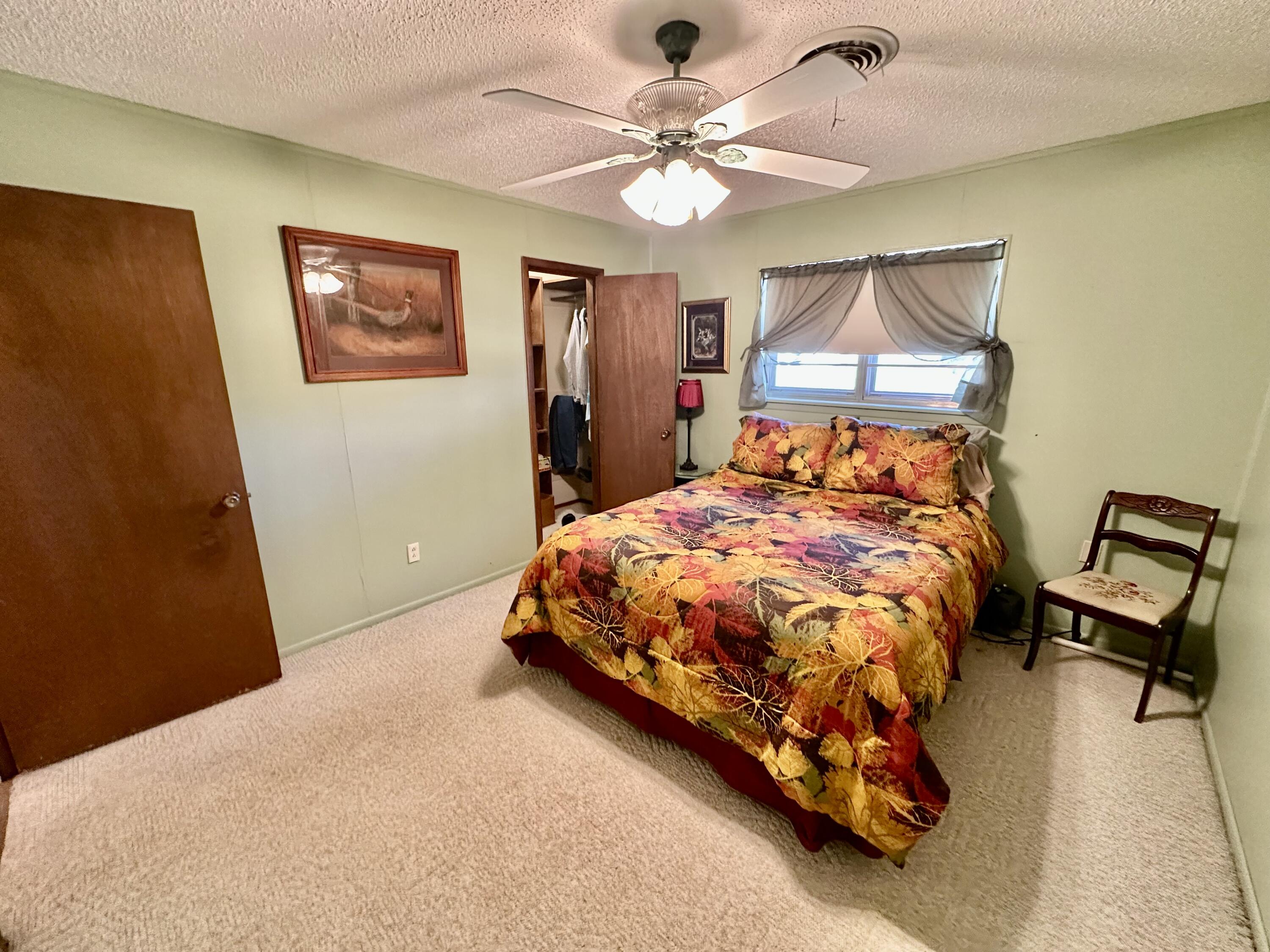 7844 Fm 1318 Tulia, TX 79088 - Photo 33 of 42 a bedroom with a bed and a chandelier