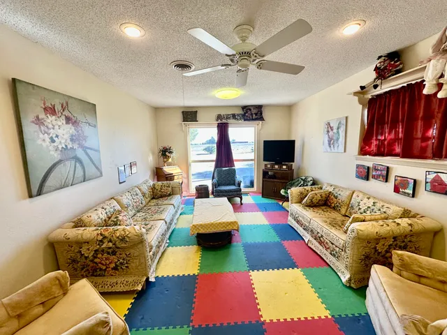 a living room with furniture fireplace and flat screen tv