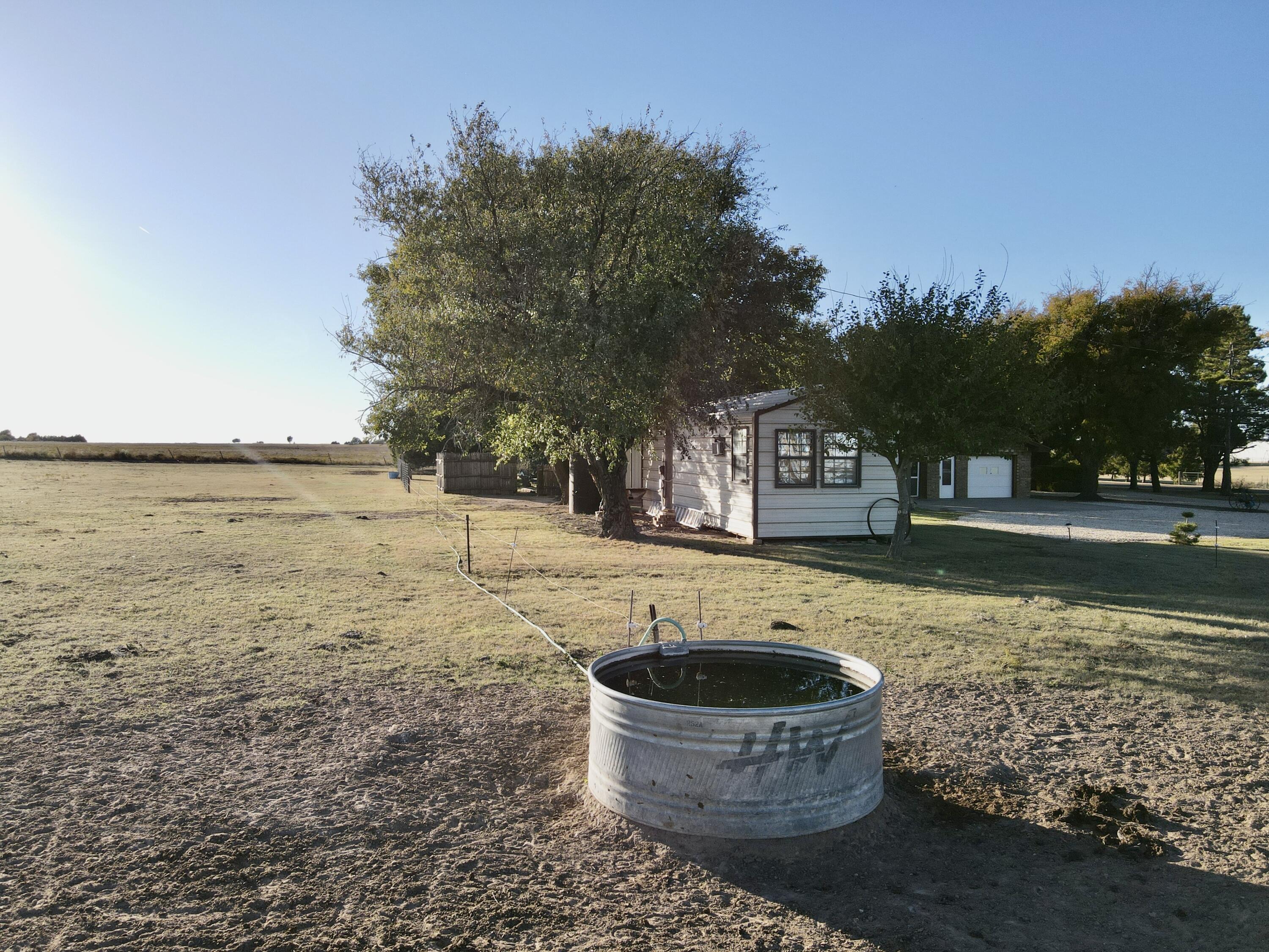 7844 Fm 1318 Tulia, TX 79088 - Photo 7 of 42 a swimming pool with outdoor seating and yard in back
