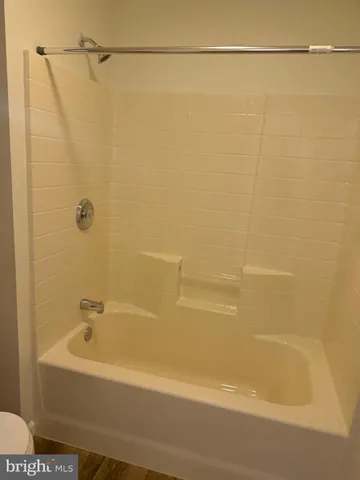 a bathroom with a shower and a bath tub