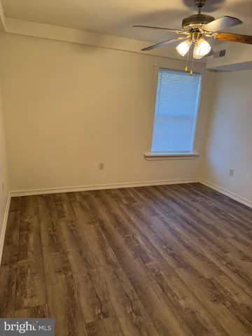 a view of room with window and wooden floor