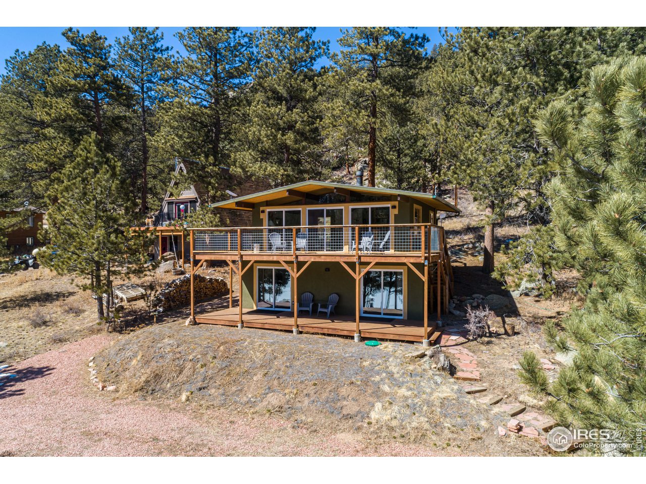 a view of a house with a yard and sitting area