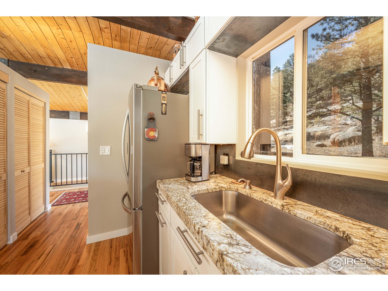 245 Hemlock Drive Lyons, CO 80540 - Photo 16 of 34 a kitchen with a sink a refrigerator and a window
