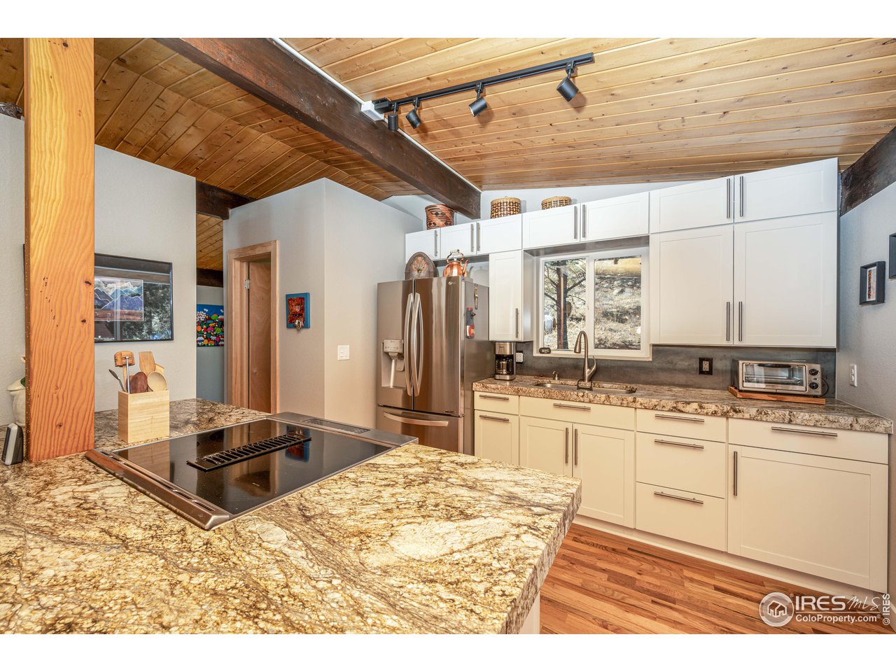 245 Hemlock Drive Lyons, CO 80540 - Photo 17 of 34 a kitchen with stainless steel appliances kitchen island granite countertop a sink and cabinets