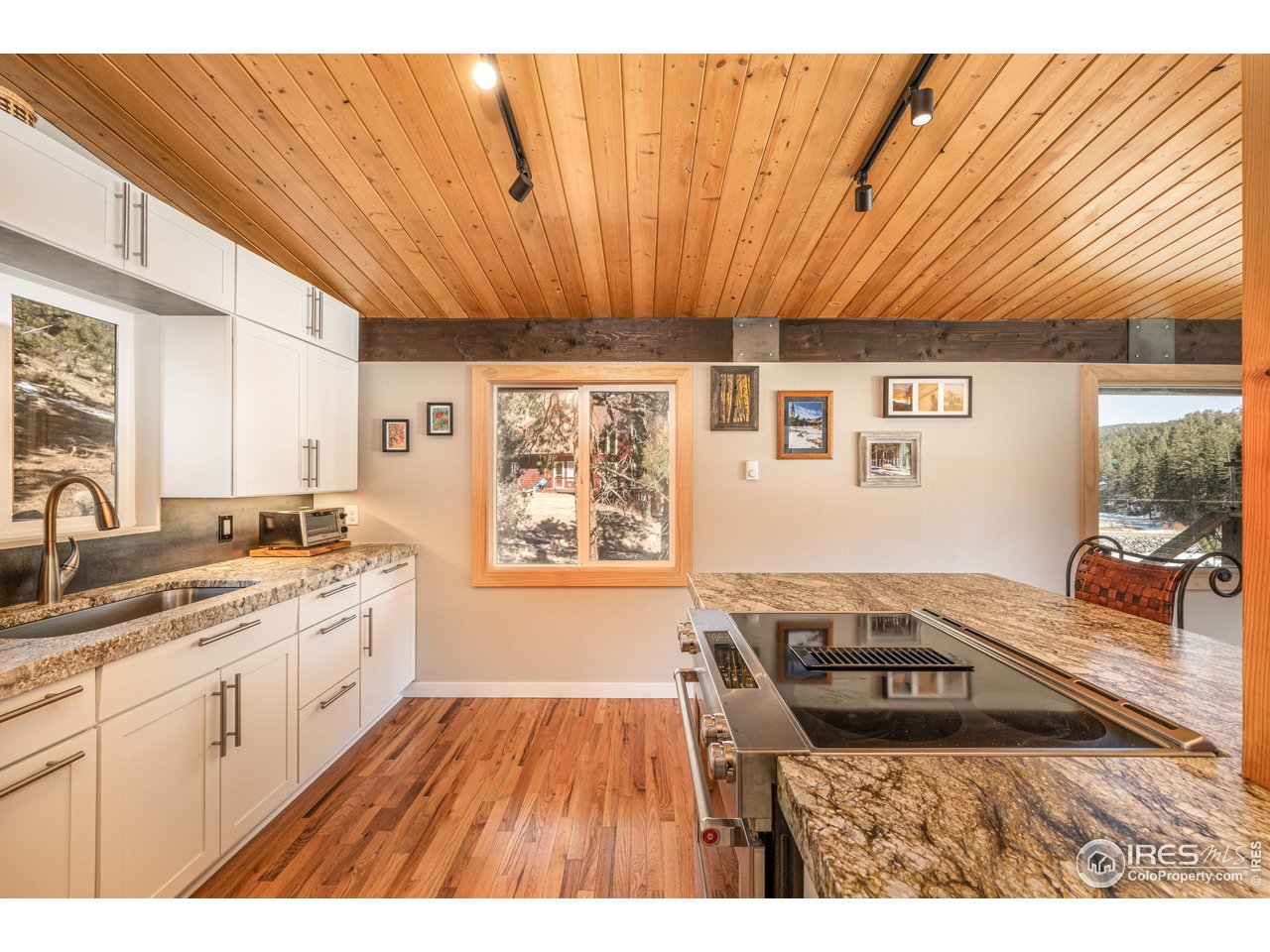 245 Hemlock Drive Lyons, CO 80540 - Photo 18 of 34 a open kitchen with a sink and wooden cabinets