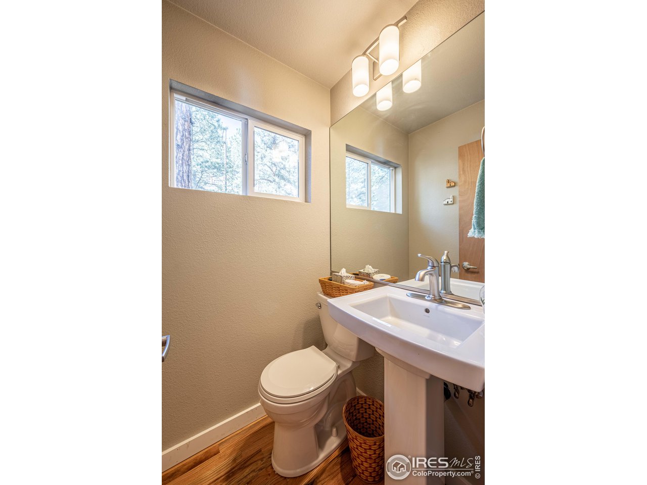 245 Hemlock Drive Lyons, CO 80540 - Photo 19 of 34 a bathroom with a toilet a sink and a mirror