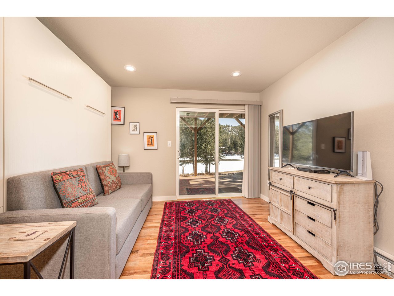 245 Hemlock Drive Lyons, CO 80540 - Photo 21 of 34 a living room with furniture and a flat screen tv