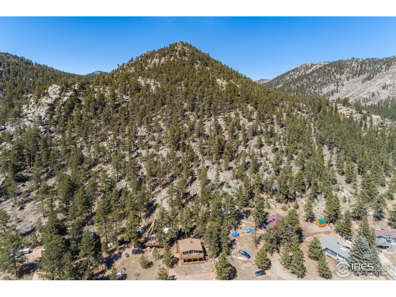 245 Hemlock Drive Lyons, CO 80540 - Photo 28 of 34 a view of a large building with mountains in the background