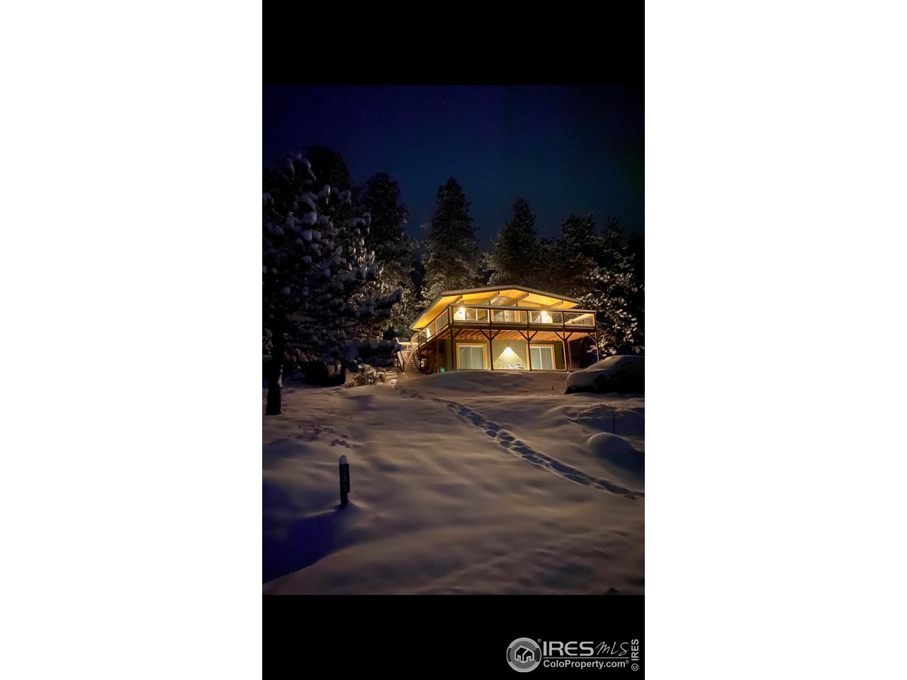 245 Hemlock Drive Lyons, CO 80540 - Photo 33 of 34 a view of a living room with a chair and frames on the wall
