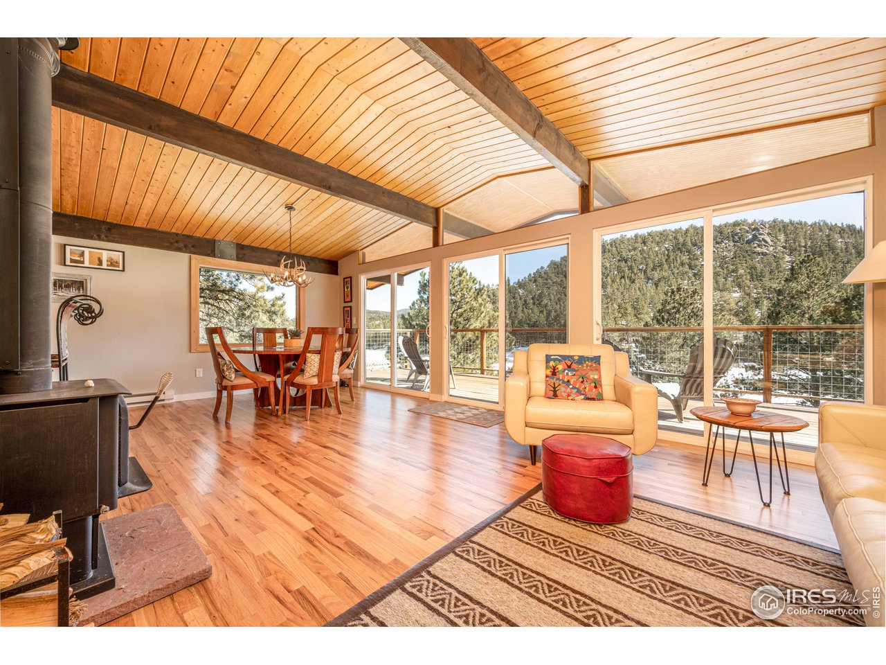 245 Hemlock Drive Lyons, CO 80540 - Photo 5 of 34 a living room with furniture a wooden floor and next to a window