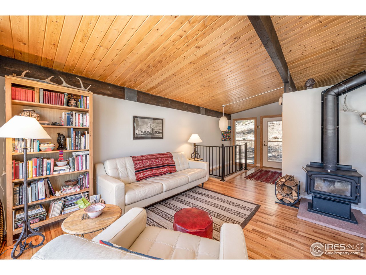 245 Hemlock Drive Lyons, CO 80540 - Photo 6 of 34 a living room with furniture and a book shelf