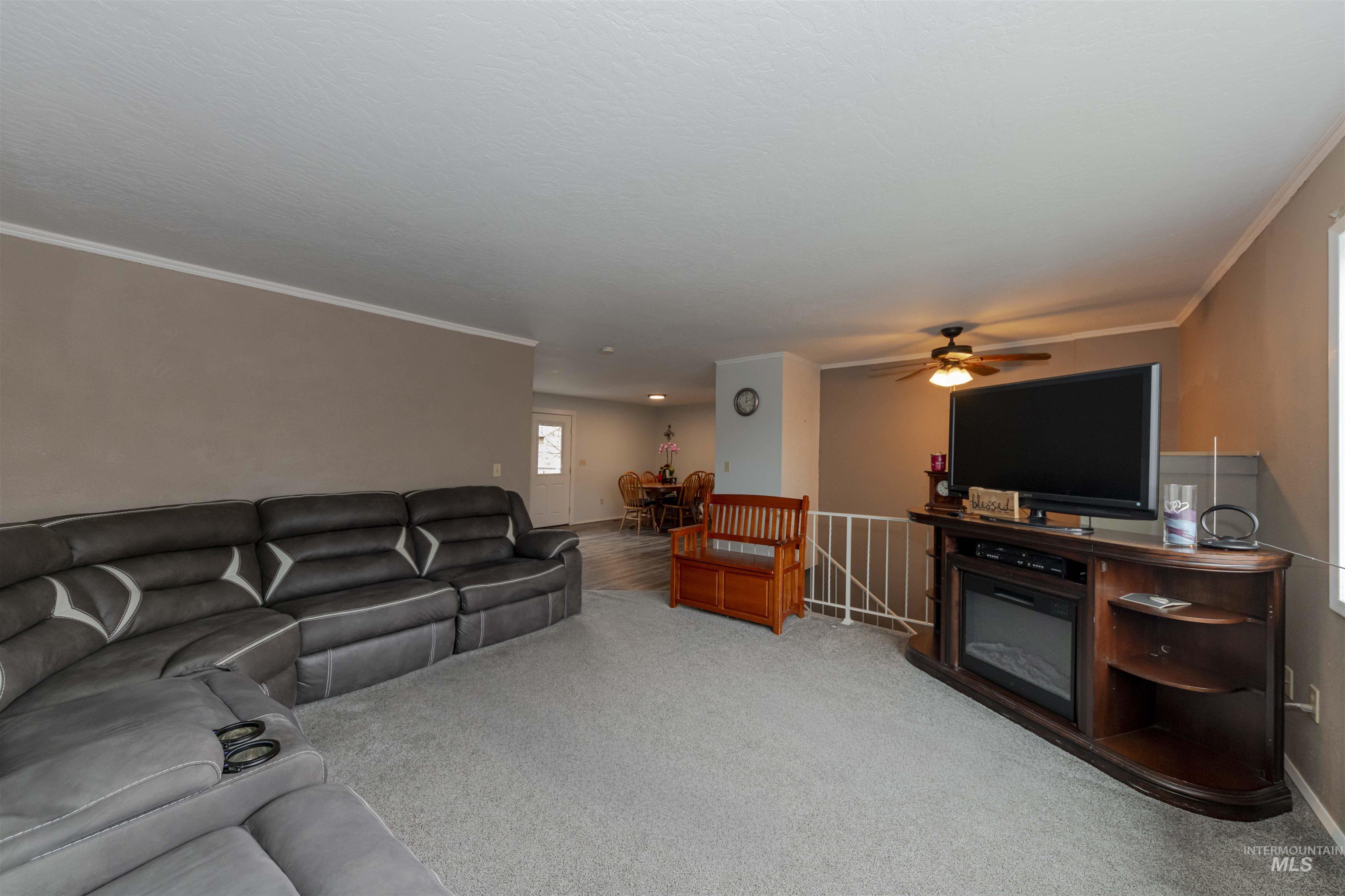 930 Preston Avenue Lewiston, ID 83501 - Photo 3 of 32 Living room featuring ornamental molding, carpet floors, and a ceiling fan