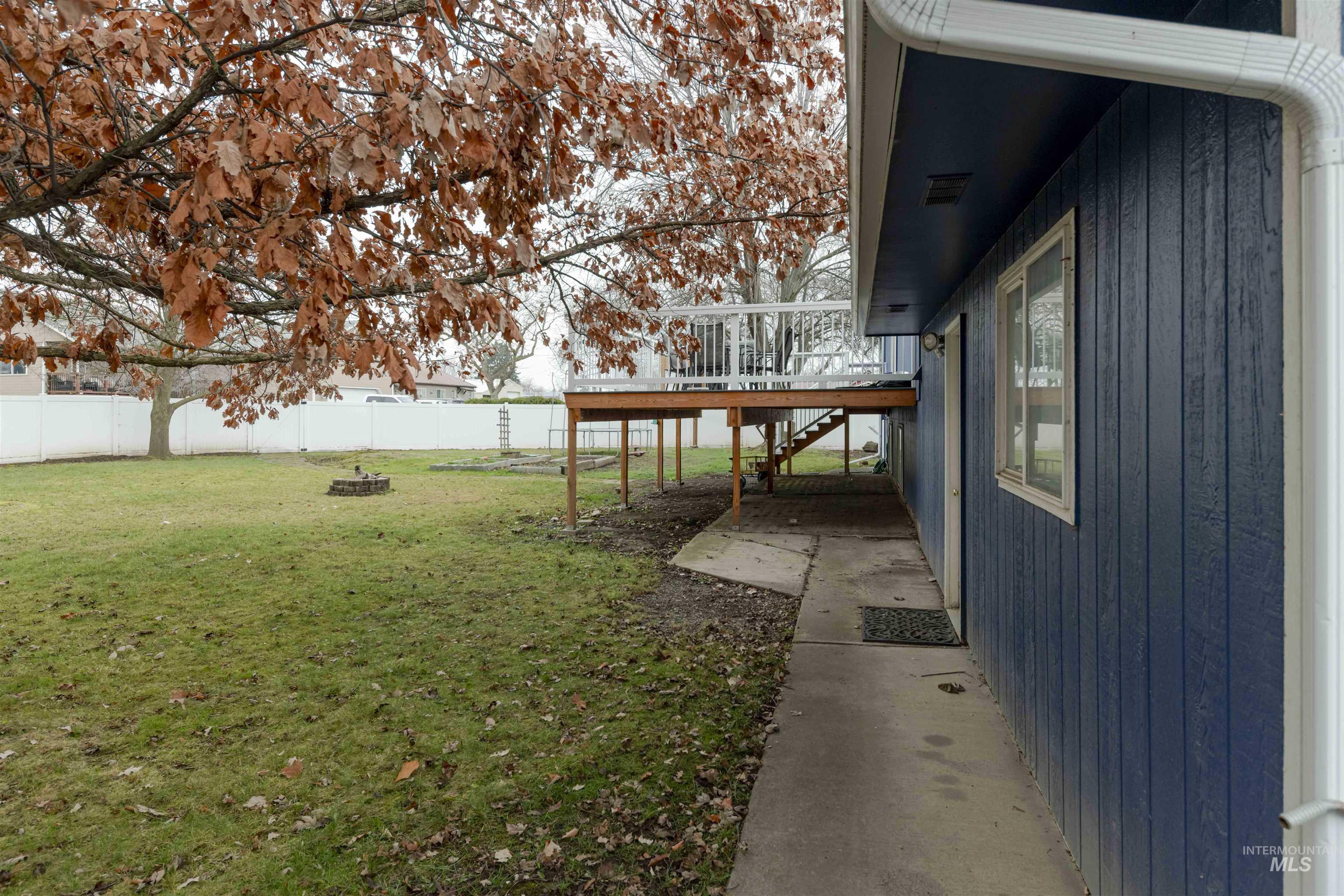 930 Preston Avenue Lewiston, ID 83501 - Photo 30 of 32 Fenced backyard featuring stairs, a deck, and a fire pit