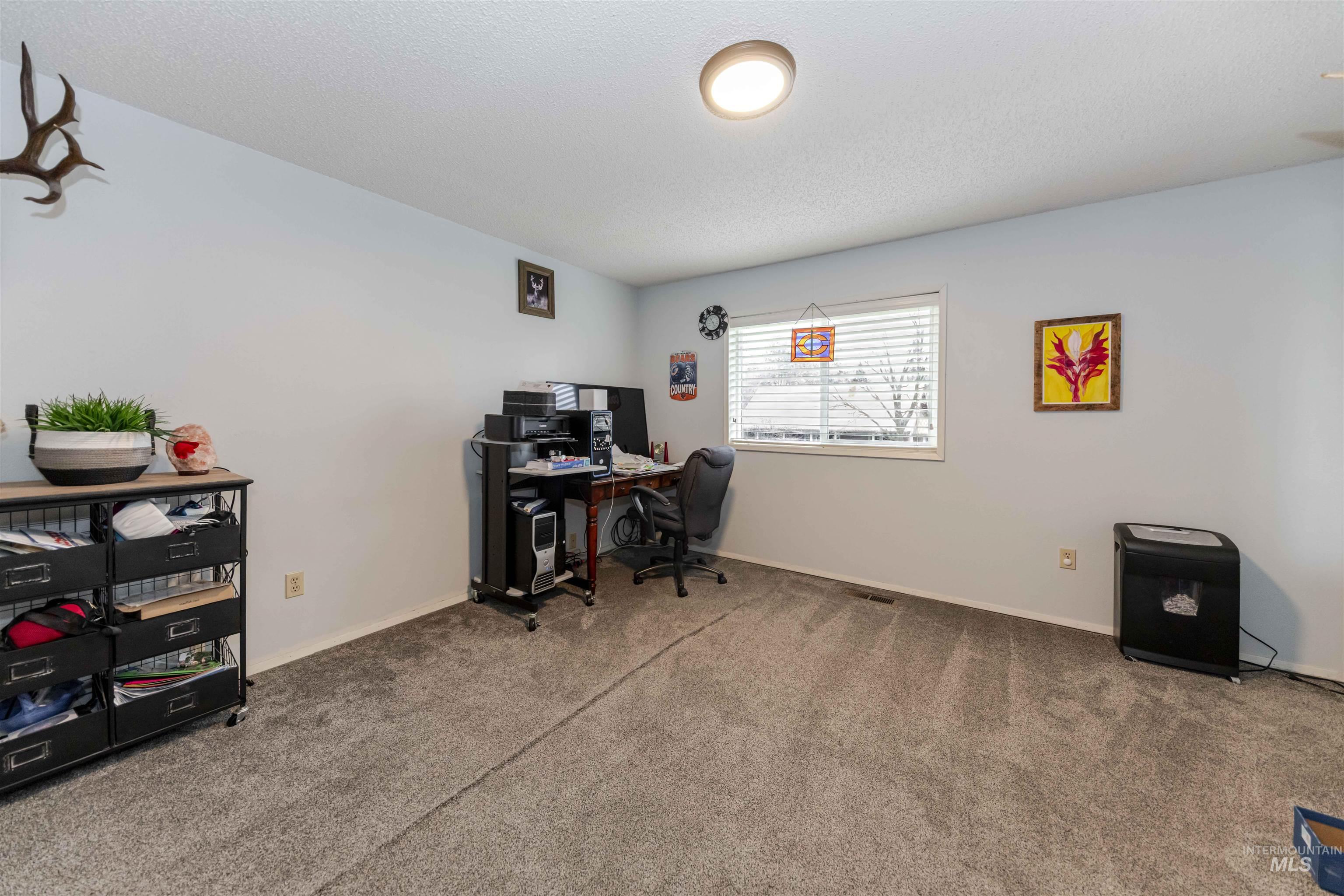 930 Preston Avenue Lewiston, ID 83501 - Photo 9 of 32 Home office with a textured ceiling and carpet floors