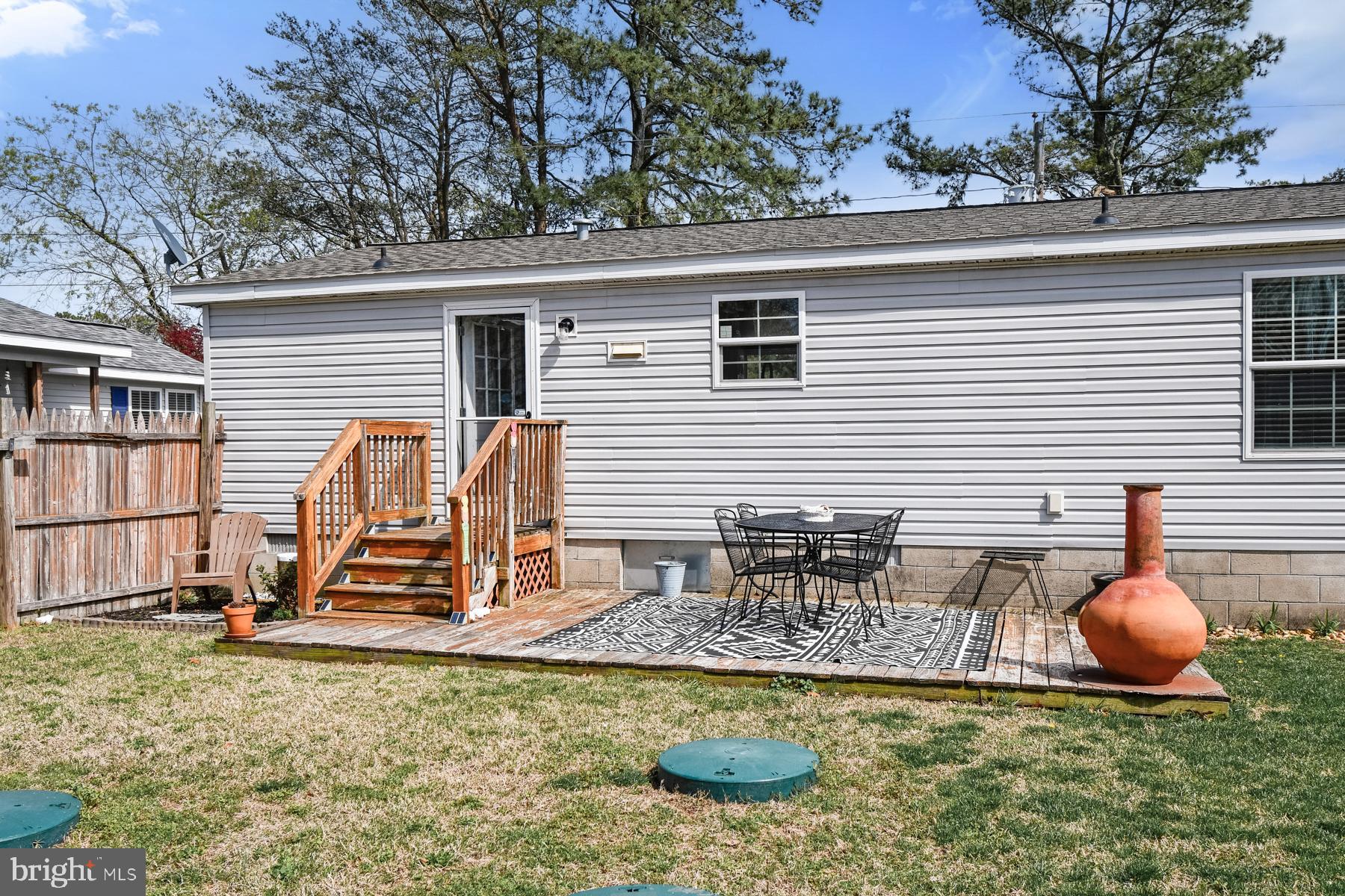 30837 West Lagoon Road Dagsboro, DE 19939 - Photo 14 of 42 a backyard of a house with barbeque oven table and chairs