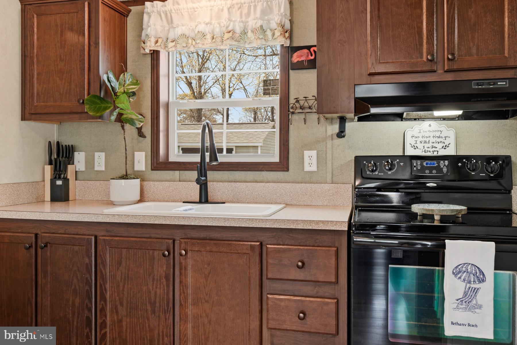 30837 West Lagoon Road Dagsboro, DE 19939 - Photo 18 of 42 a kitchen with stainless steel appliances granite countertop a stove and a microwave