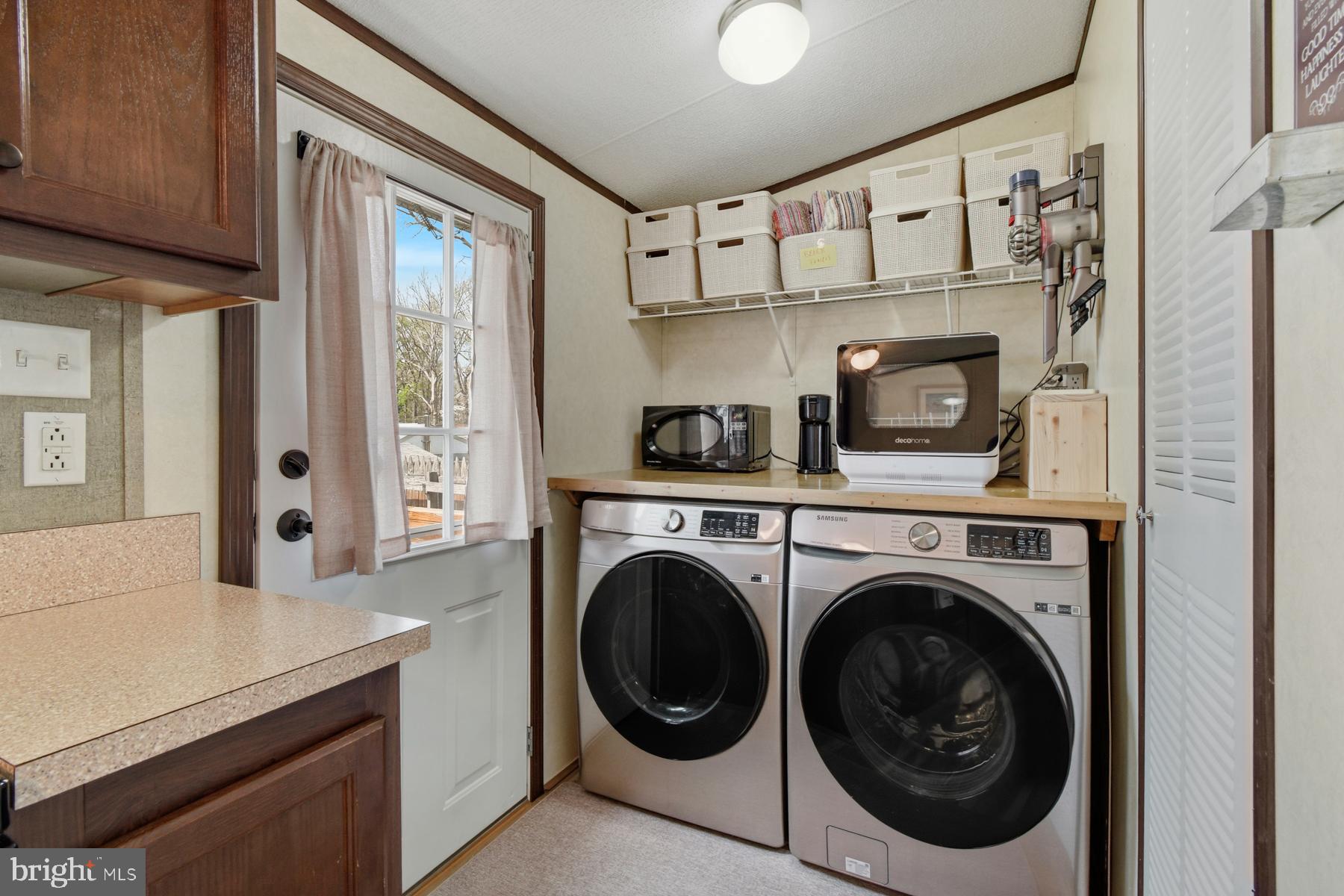 30837 West Lagoon Road Dagsboro, DE 19939 - Photo 22 of 42 a utility room with cabinets dryer and washer