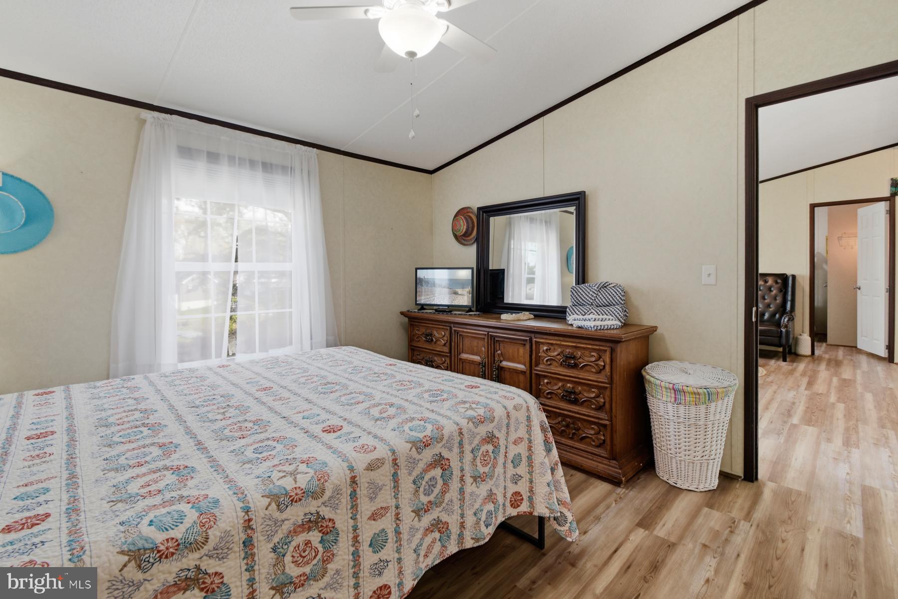 30837 West Lagoon Road Dagsboro, DE 19939 - Photo 38 of 42 a bedroom with a bed and a dresser