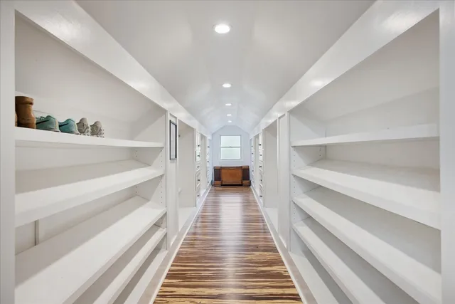 a view of a hallway with wooden floor and stairs