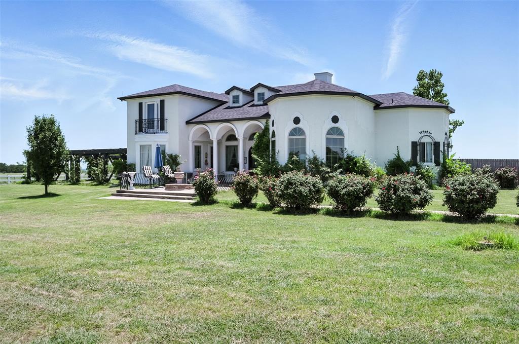 200 Union Grove Road Valley View, TX 76272 - Photo 1 of 1 French country home with stucco siding, a balcony, a front lawn, and a chimney