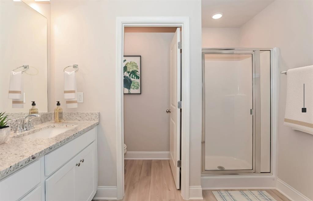 2150 Spring Rush Drive, Unit 127 Buford, GA 30519 - Photo 11 of 15 a bathroom with a granite countertop sink and a mirror