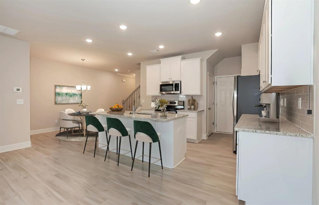 2150 Spring Rush Drive, Unit 127 Buford, GA 30519 - Photo 2 of 15 a kitchen with counter space cabinets and appliances