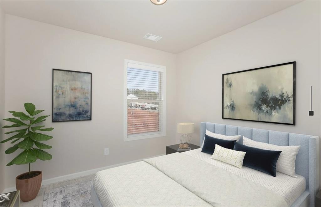 2150 Spring Rush Drive, Unit 127 Buford, GA 30519 - Photo 6 of 15 a bedroom with a large bed and a potted plant