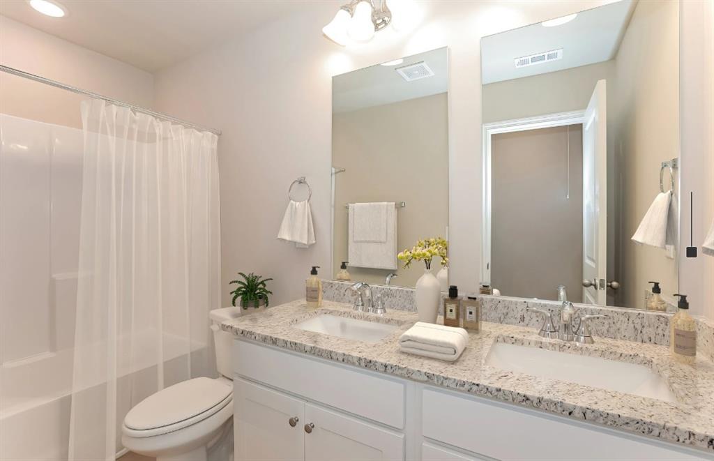 2150 Spring Rush Drive, Unit 127 Buford, GA 30519 - Photo 10 of 15 a bathroom with a granite countertop sink a toilet and a mirror