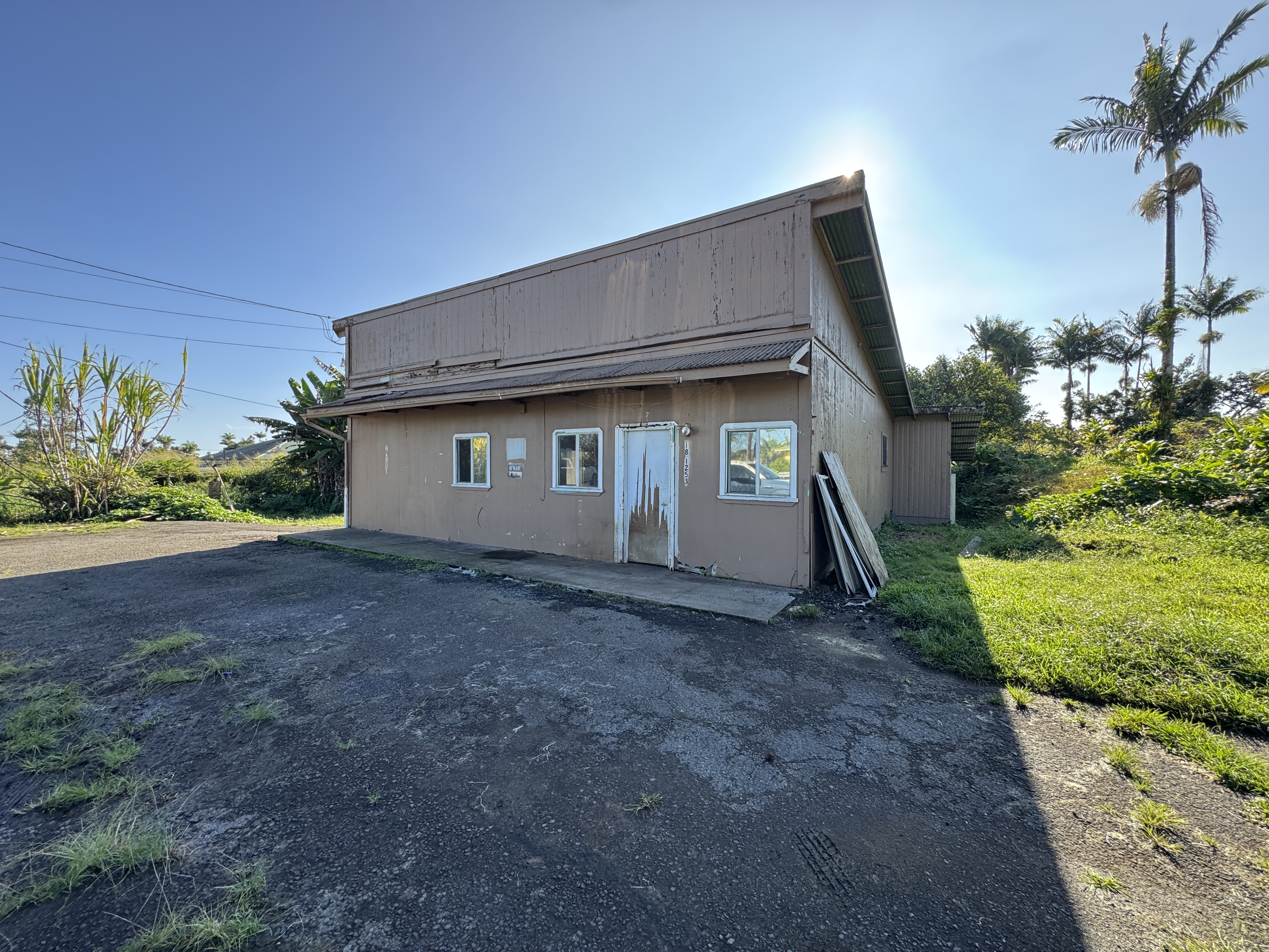 18-1253 Volcano Road Mountain View, HI 96771 - Photo 2 of 23 a view of a house with a yard and plants