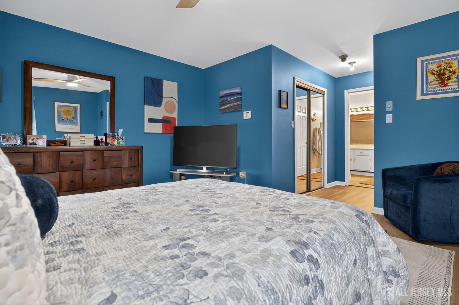 5 Scarborough Road, Unit D Monroe Township, NJ 08831 - Photo 11 of 28 a bedroom with a bed and dresser with mirror