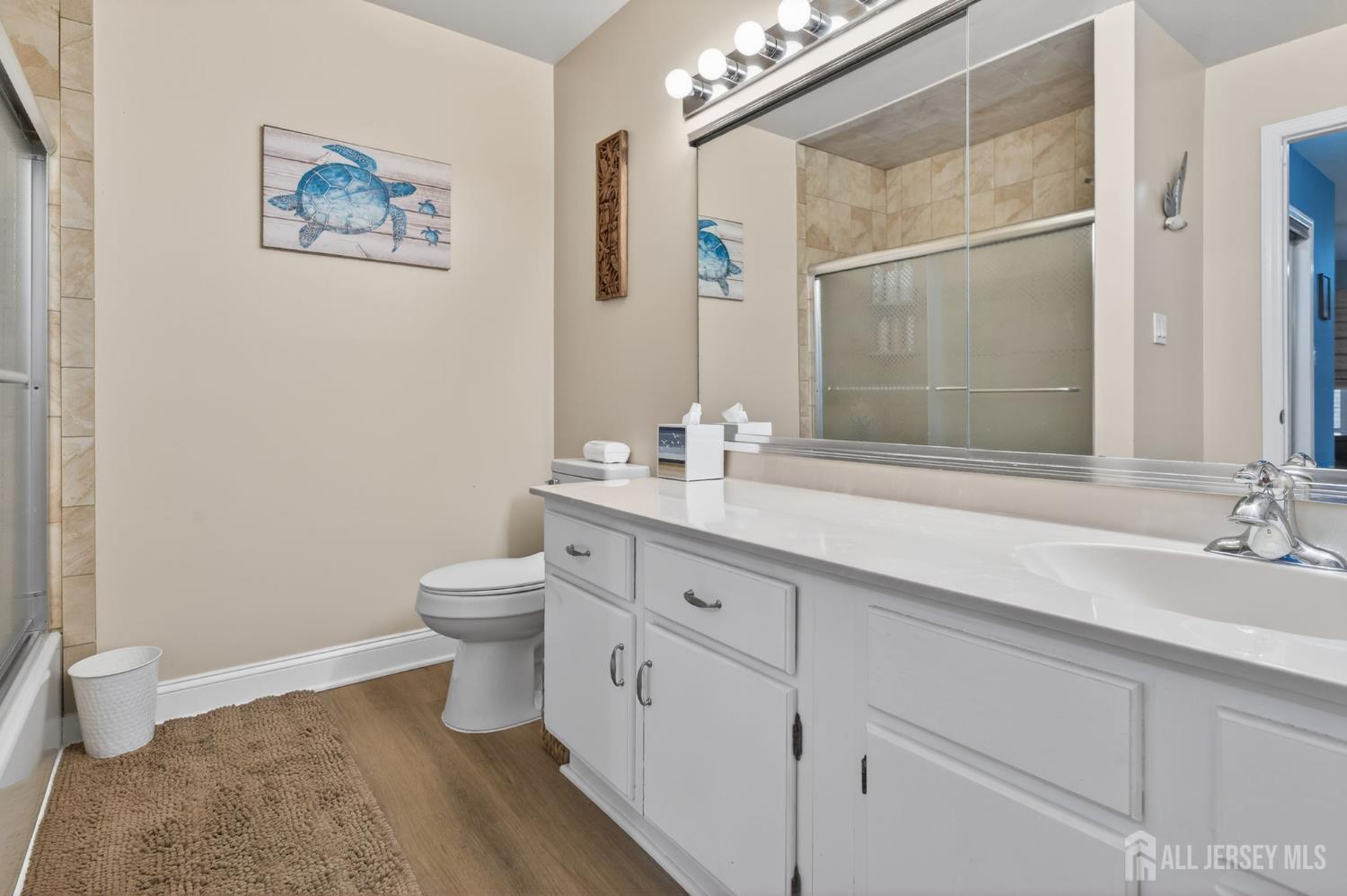 5 Scarborough Road, Unit D Monroe Township, NJ 08831 - Photo 13 of 28 a bathroom with a double vanity sink a toilet and a mirror