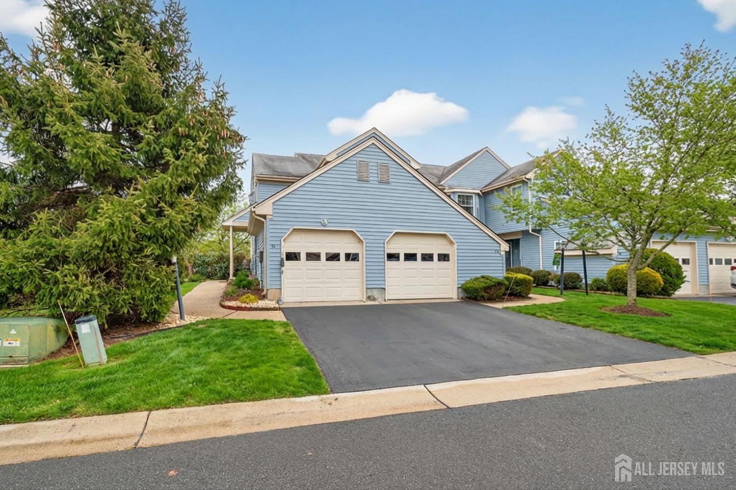 5 Scarborough Road, Unit D Monroe Township, NJ 08831 - Photo 20 of 28 a front view of a house with a yard and garage