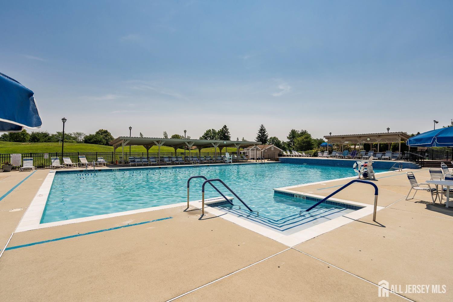 5 Scarborough Road, Unit D Monroe Township, NJ 08831 - Photo 23 of 28 a view of a swimming pool with a lawn chairs