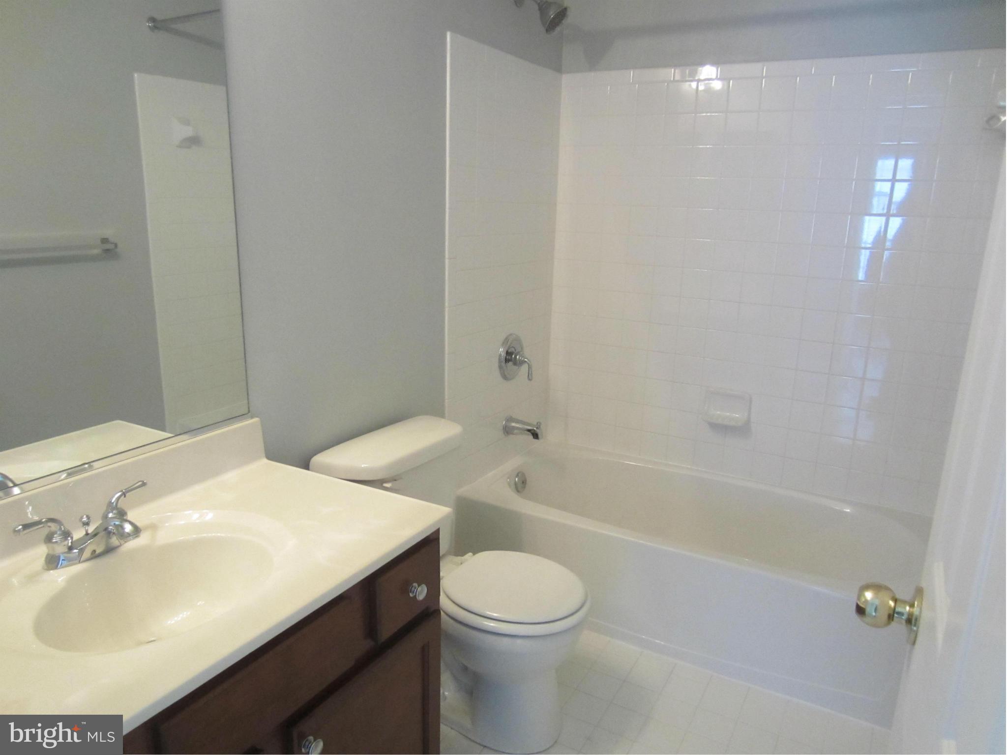 9624 Maxwell Road Middle River, MD 21220 - Photo 22 of 30 a bathroom with a sink toilet vanity and shower