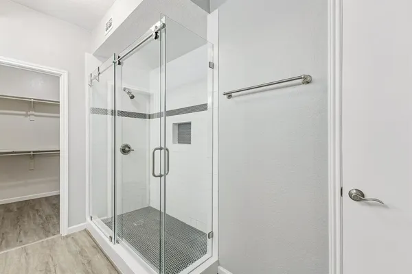 a bathroom with a glass shower door