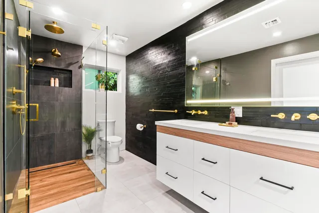 a bathroom with a sink a vanity and a shower