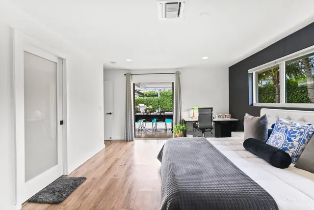a bedroom with a bed and large window