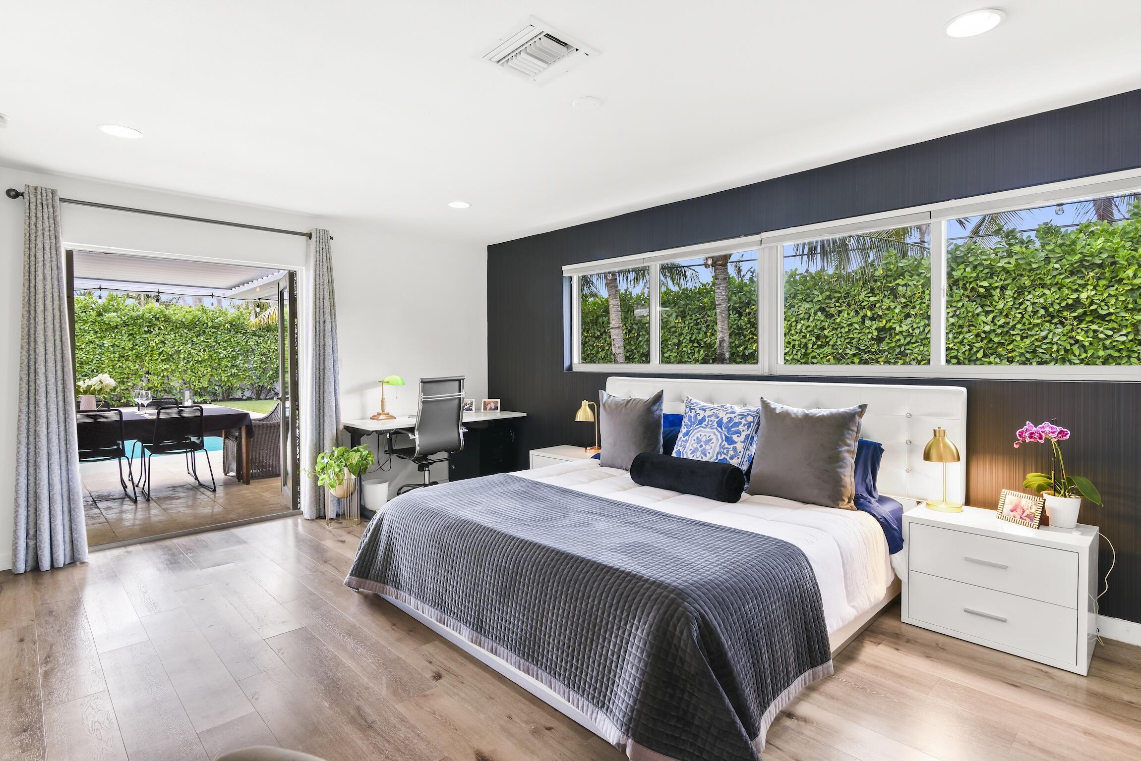 3481 Northeast 31st Avenue Lighthouse Point, FL 33064 - Photo 14 of 33 a bedroom with a bed and large windows